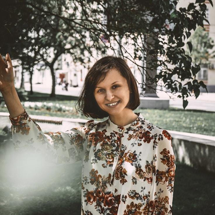 Avery Chen, Lead Design Curator at RidgePlumeHome, reviewing corporate floral arrangements